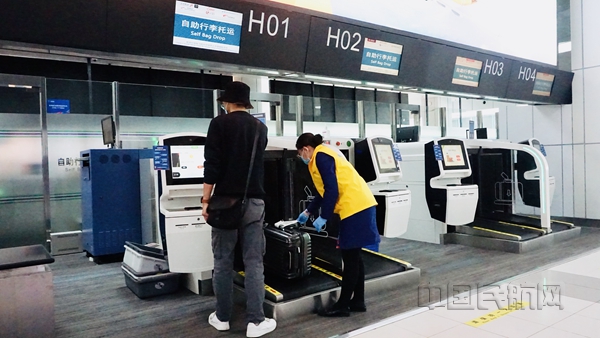 旅客在工作人员引导下办理自助托运手续_副本.jpg